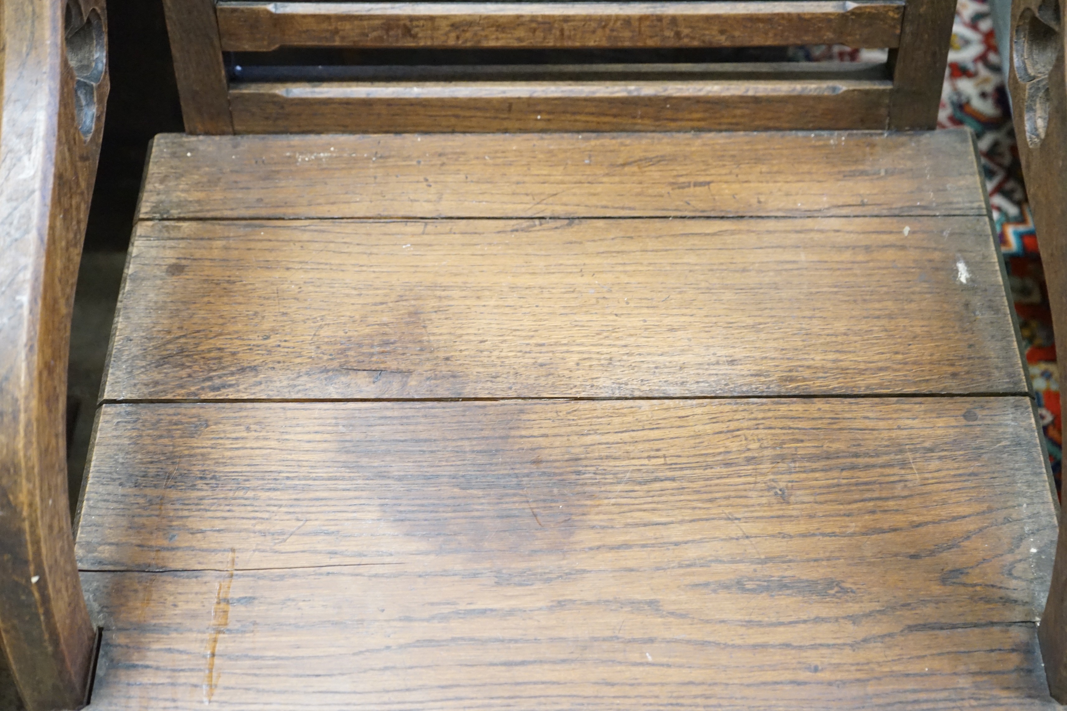 A pair of carved oak Glastonbury type chairs, width 58cm, depth 48cm, height 86cm